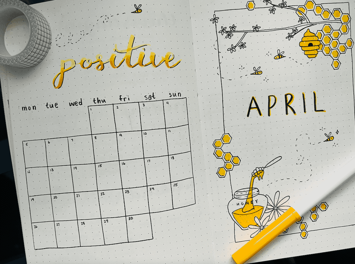 This is a monthly calendar layout with doodles of bee hives and a quote that says "bee positive".